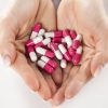 fists full of pills on a white background fists full of pills on a white background