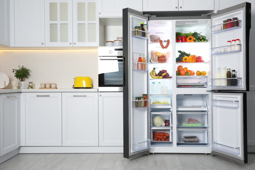 Open refrigerator filled with food in kitchen low temperature plasticizer example