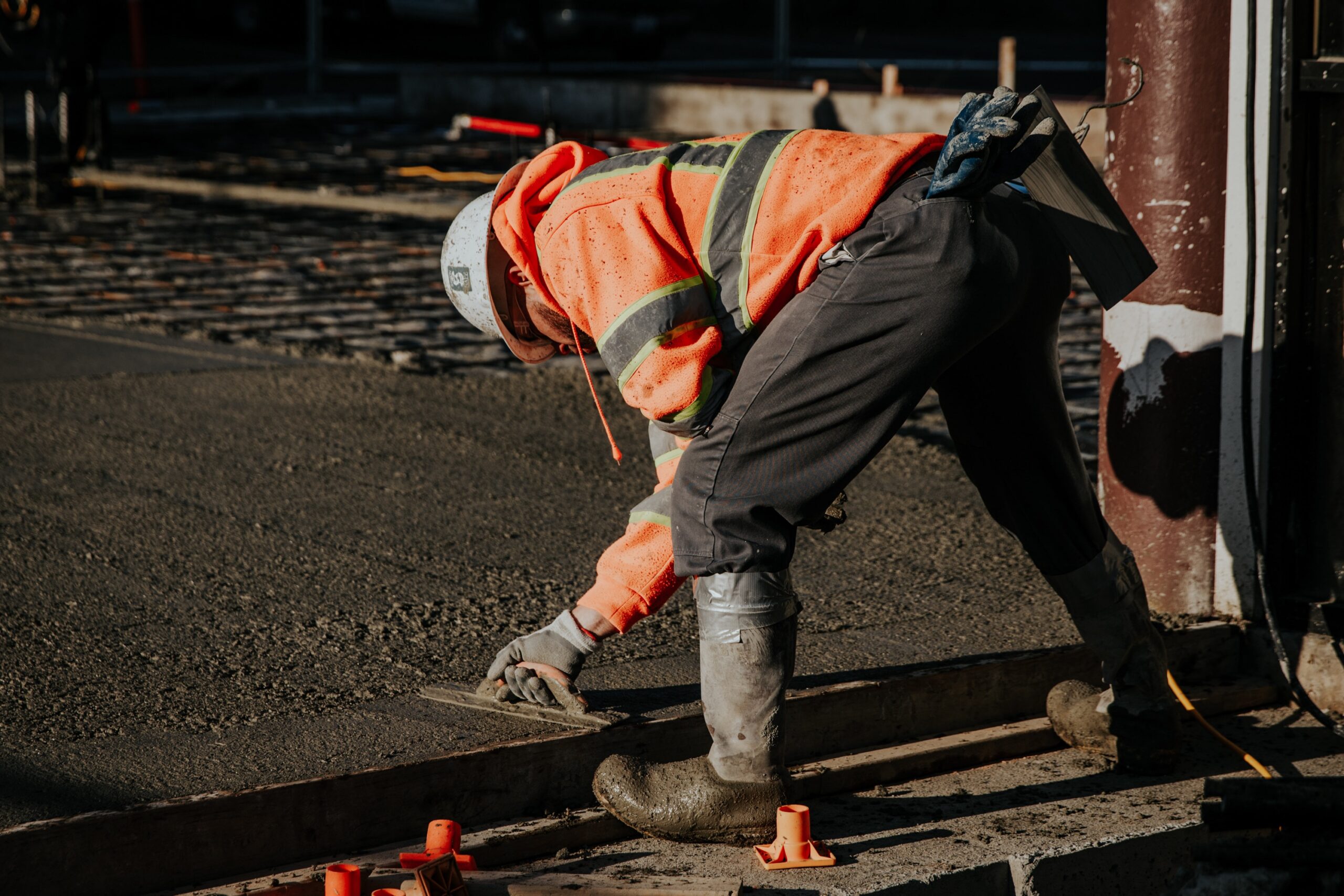 construction worker laying concrete
