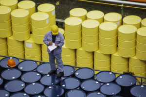 Male worker inspection record drum oil stock barrels yellow vertical or chemical for transportation truck male in the industry